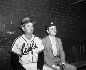 Jack_Kent_Cooke_with_baseball_player_in_Toronto_Maple_Leafs_Baseball_Club_dugout,_Maple_Leaf_Stadium